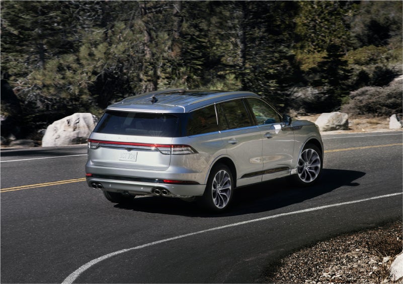 A 2023 Lincoln Aviator® Grand Touring model is shown being driven on a tight turn of a mountain road | Libertyville Lincoln Sales, Inc. in Libertyville IL