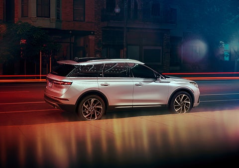 A 2023 Lincoln Corsair® SUV is shown parked in the city at night. | Libertyville Lincoln Sales, Inc. in Libertyville IL