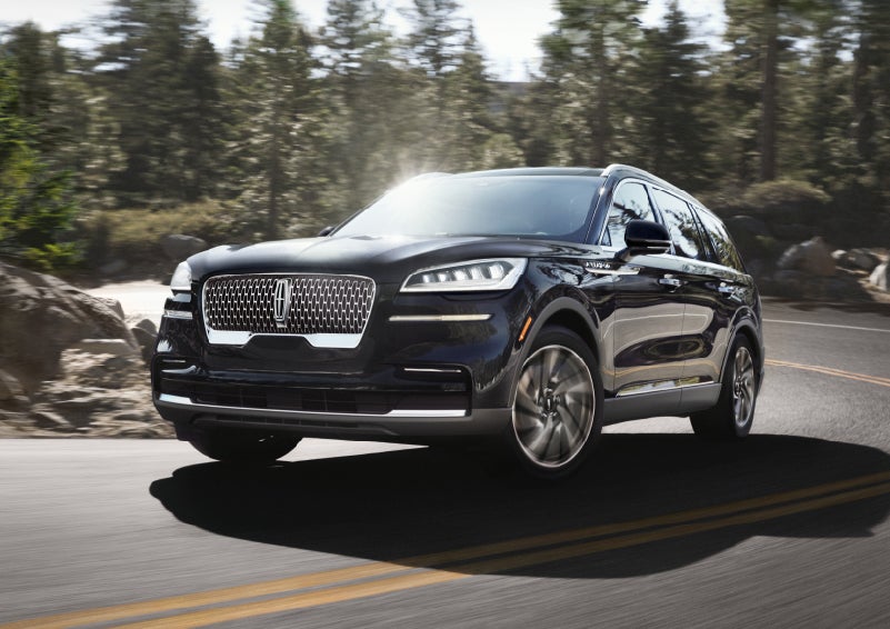 A Lincoln Aviator® SUV is being driven on a winding mountain road | Libertyville Lincoln Sales, Inc. in Libertyville IL