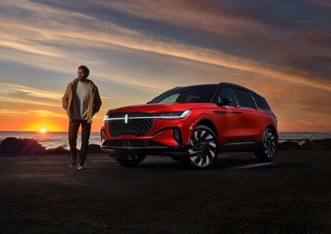 A person is shown next to a 2024 Lincoln Nautilus® SUV as the Lincoln Embrace sequence takes place. | Libertyville Lincoln Sales, Inc. in Libertyville IL