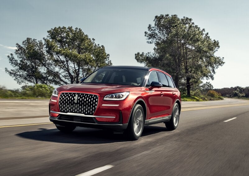 A 2025 Lincoln Corsair® SUV is shown being driven on a country road. | Libertyville Lincoln Sales, Inc. in Libertyville IL