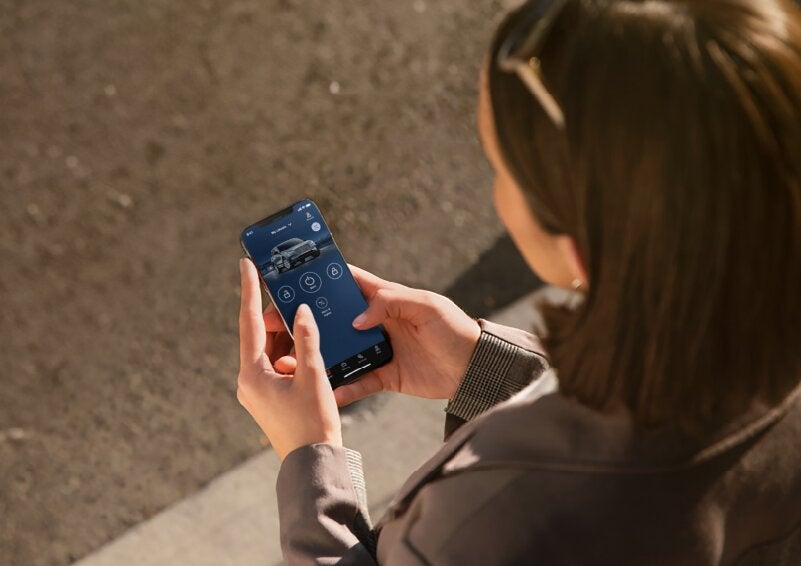 A person is shown interacting with a smartphone to connect to a Lincoln vehicle via the Lincoln Way® App. | Libertyville Lincoln Sales, Inc. in Libertyville IL