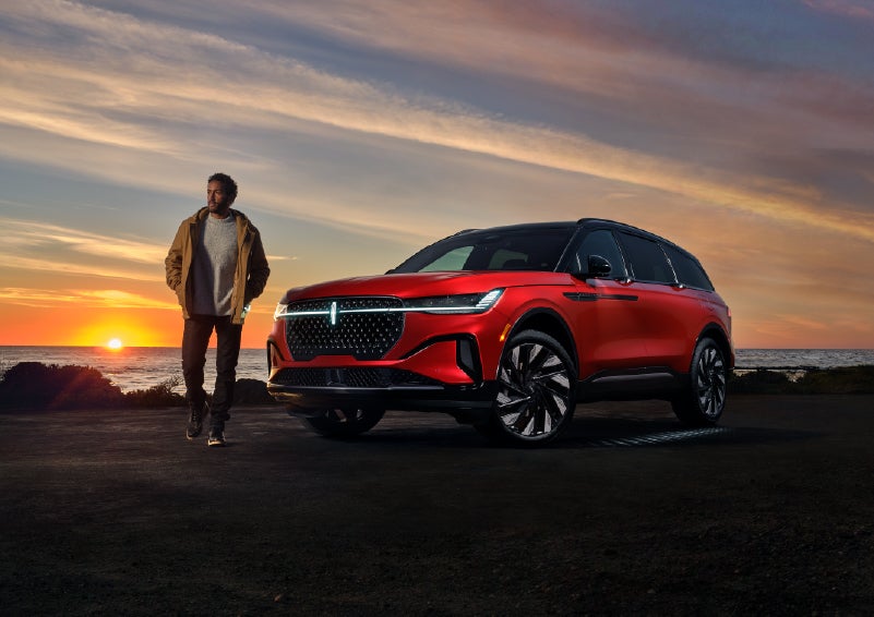 A person is shown next to a 2025 Lincoln Nautilus® SUV as the Lincoln Embrace sequence takes place. | Libertyville Lincoln Sales, Inc. in Libertyville IL