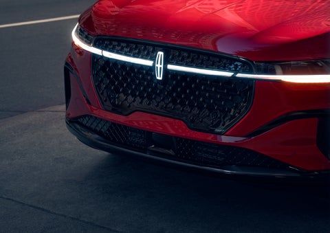 The available front LED light bar and center Lincoln Star logo glow at dusk. | Libertyville Lincoln Sales, Inc. in Libertyville IL