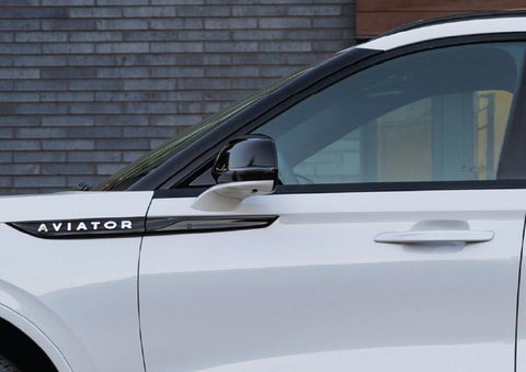 The driver’s side door and fender badging of a white 2026 Lincoln Aviator® SUV are showcased. | Libertyville Lincoln Sales, Inc. in Libertyville IL