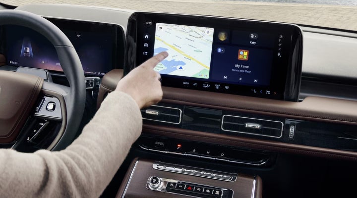 A person is tapping the center display touchscreen of a 2026 Lincoln Aviator® SUV. | Libertyville Lincoln Sales, Inc. in Libertyville IL