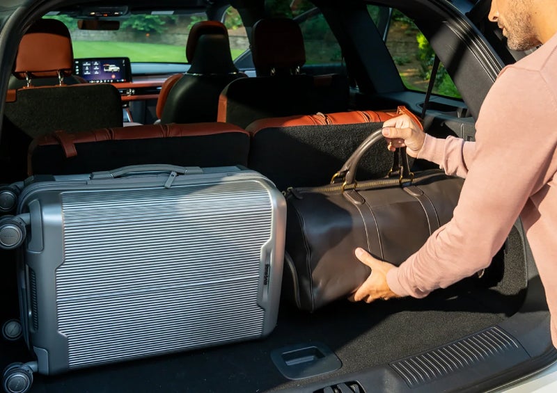 A man loads luggage into the rear of a 2026 Lincoln Aviator® SUV through the opened rear liftgate. | Libertyville Lincoln Sales, Inc. in Libertyville IL