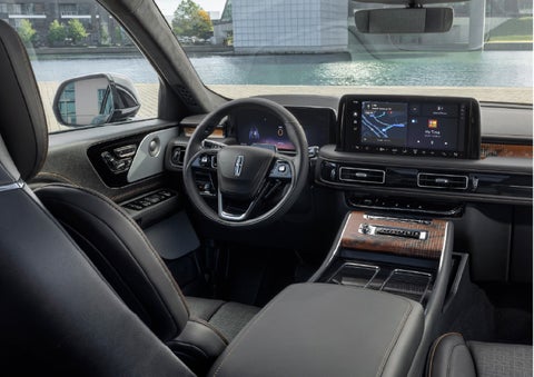 The interior of the 2026 Lincoln Aviator® SUV is shown parked with a view of a harbor through the windshield. | Libertyville Lincoln Sales, Inc. in Libertyville IL