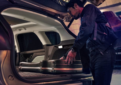 A man is shown loading cargo into the rear of a 2026 Lincoln Corsair® SUV with the second-row seats folded flat. | Libertyville Lincoln Sales, Inc. in Libertyville IL
