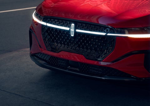 The available front LED light bar and center Lincoln Star logo glow at dusk. | Libertyville Lincoln Sales, Inc. in Libertyville IL