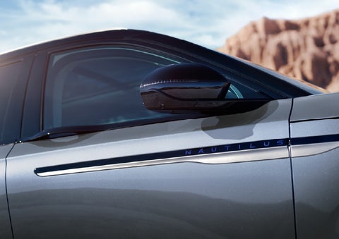 Blue lettering on the side of the vehicle that reads Nautilus indicates the available Hybrid Powertrain. | Libertyville Lincoln Sales, Inc. in Libertyville IL