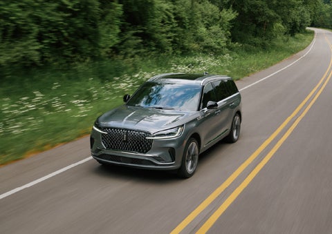 A 2027 Lincoln Aviator® SUV is being driven down a road. | Libertyville Lincoln Sales, Inc. in Libertyville IL