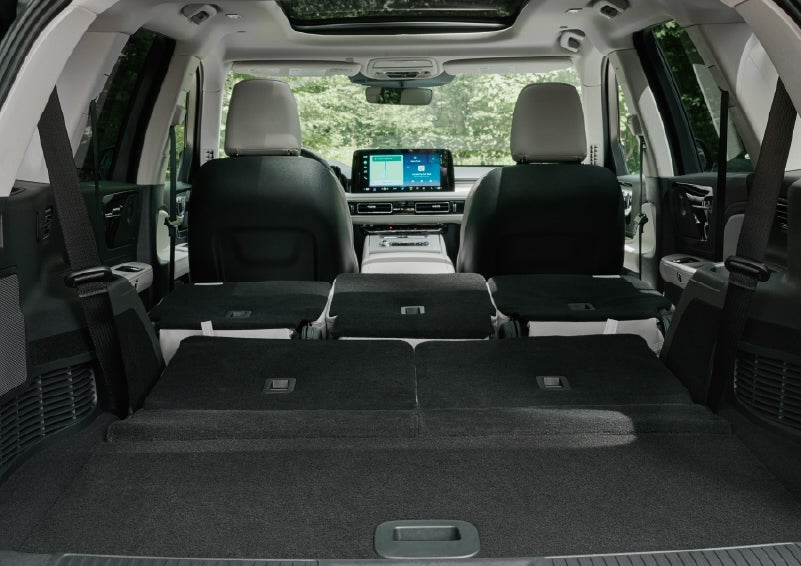 A rear to front view of the interior of a 2027 Lincoln Aviator® Black Label™ SUV shows the third and second rows folded flat | Libertyville Lincoln Sales, Inc. in Libertyville IL