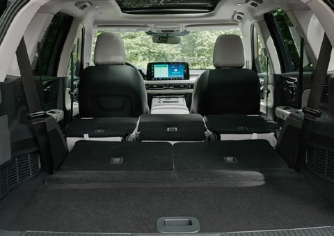 A rear to front view of the interior of a 2027 Lincoln Aviator® Black Label™ SUV shows the third and second rows folded flat | Libertyville Lincoln Sales, Inc. in Libertyville IL