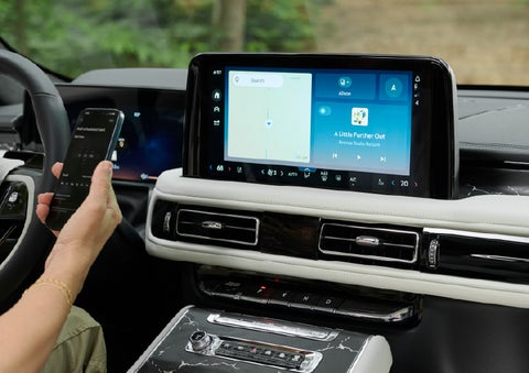 A person pairs thier phone with the center touchscreen of a 2027 Lincoln Aviator® Black Label™ SUV | Libertyville Lincoln Sales, Inc. in Libertyville IL